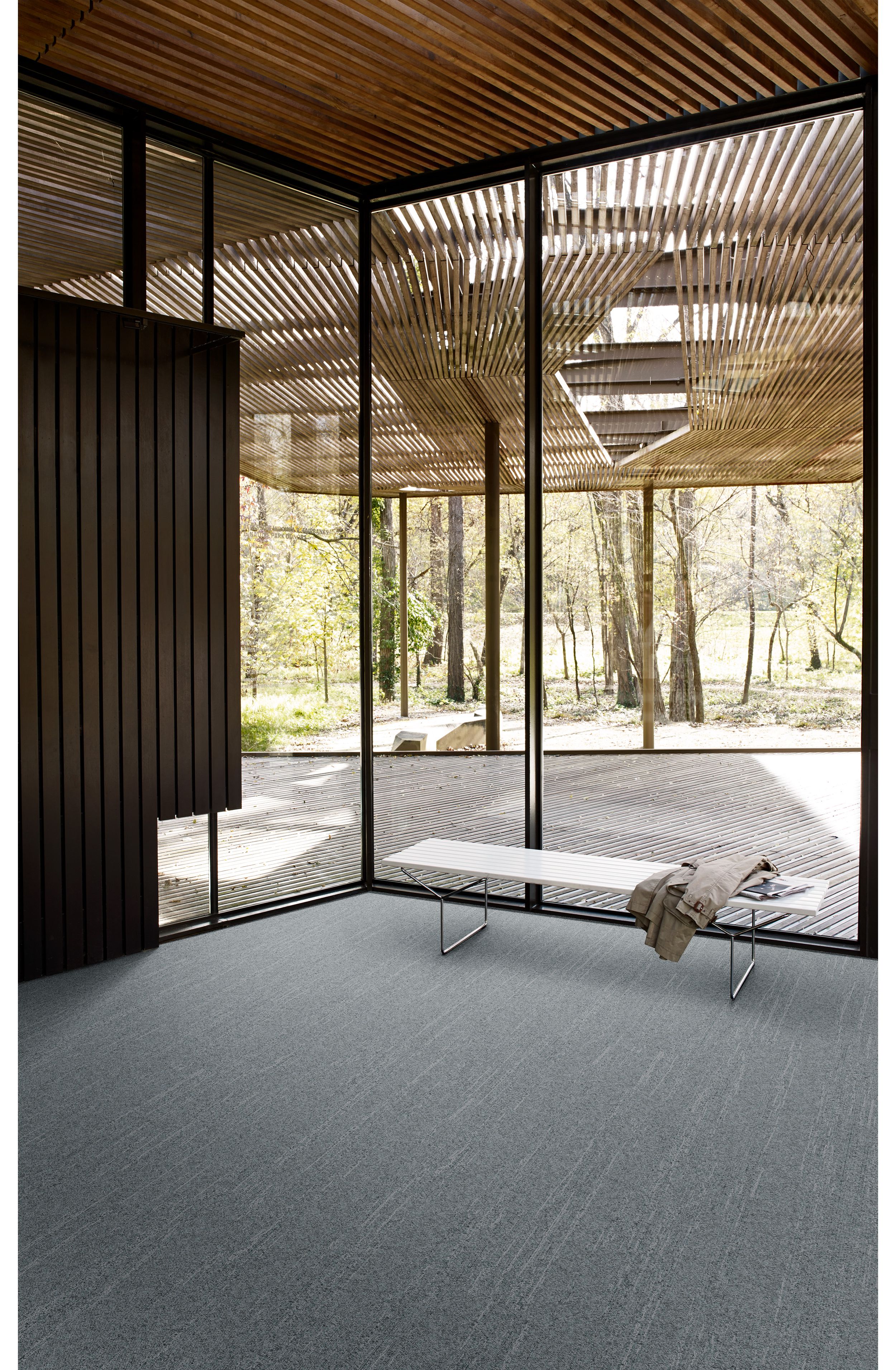 Interface Tide Pool Ripple carpet tile in open room with bench and jacket imagen número 1